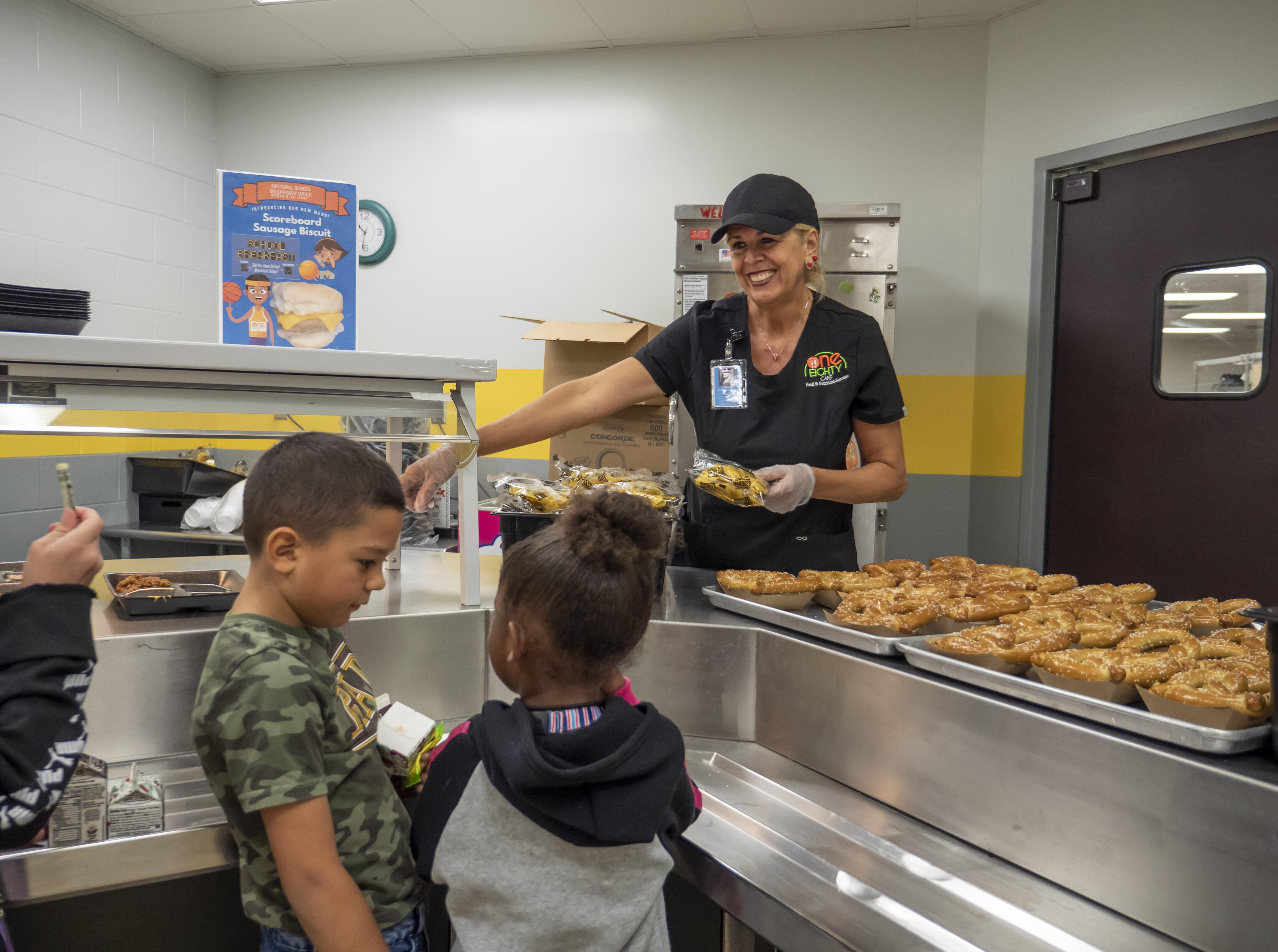 Cafeteria worker serving students